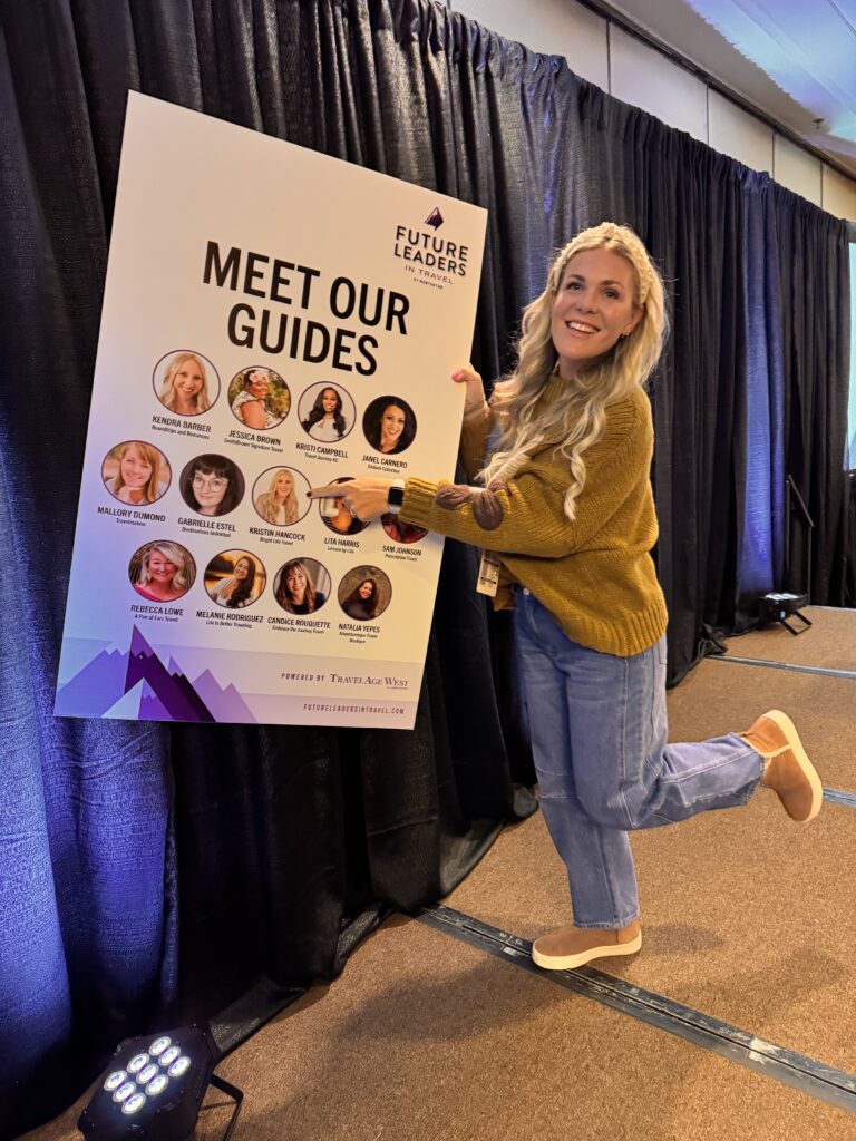 Kristin Hancock holding guide sign for Future Leaders in Travel