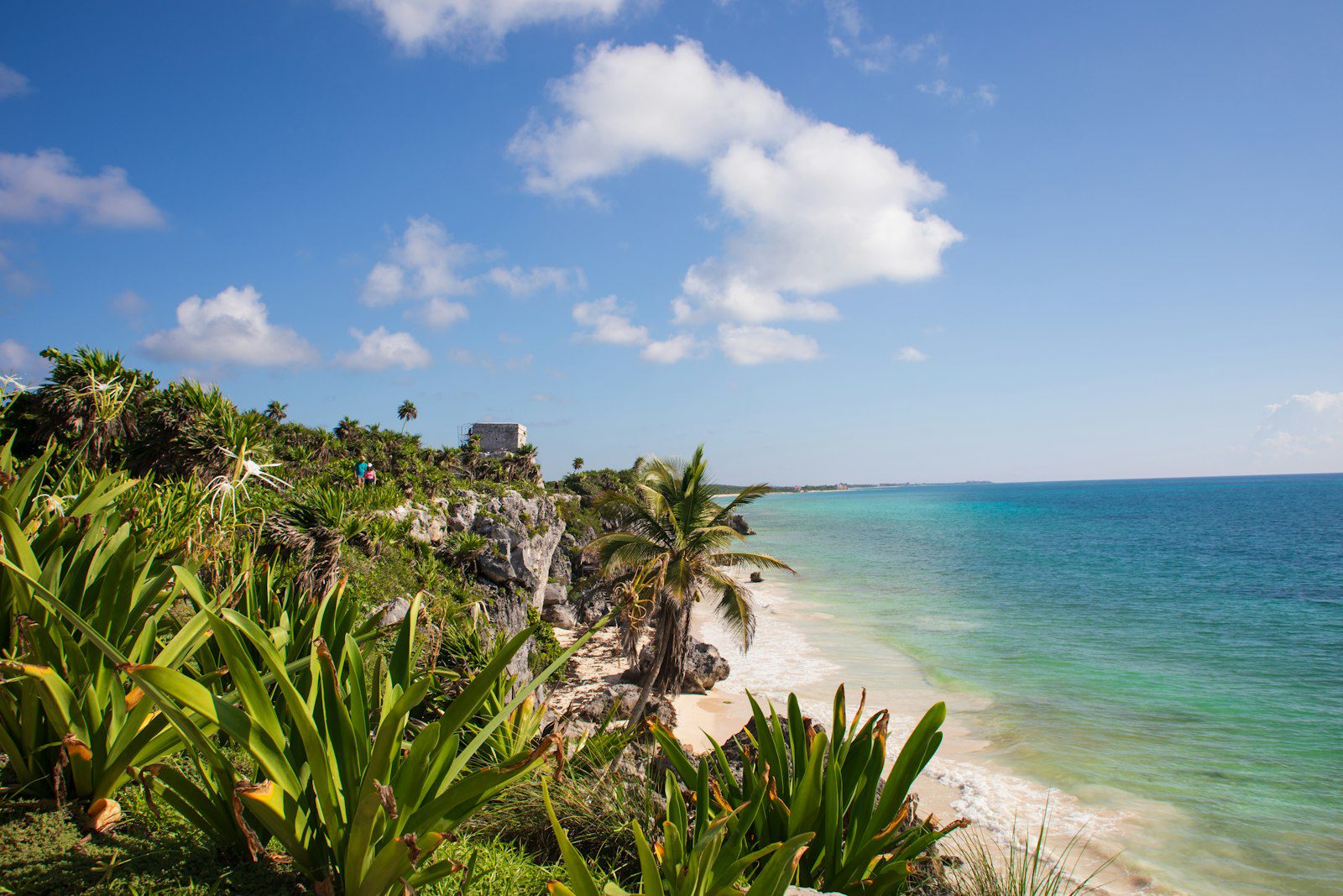 Tulum ruins on a cliff above a white sand beach in the Riviera Maya, Mexico
